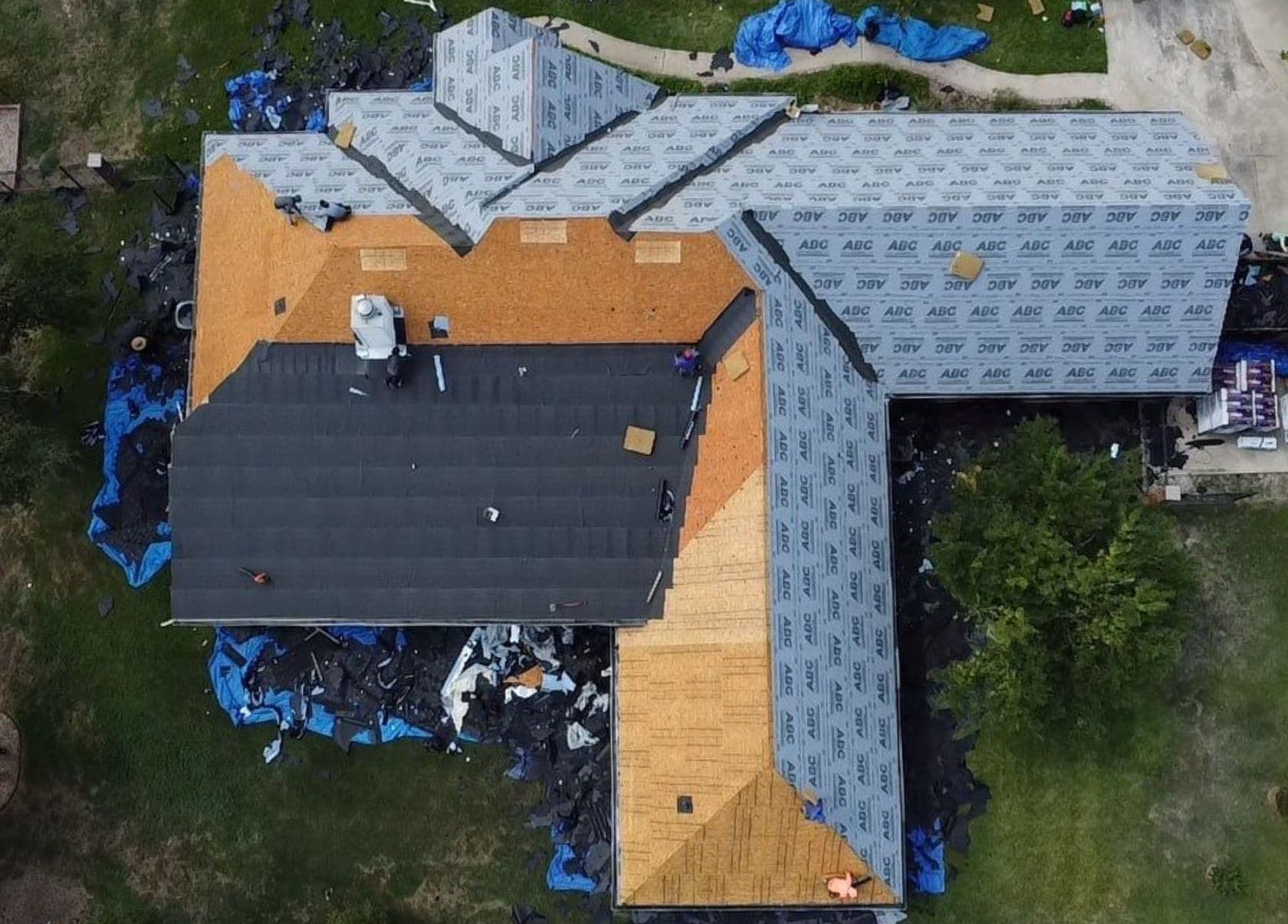 Aerial view of a shingle roof replacement in progress